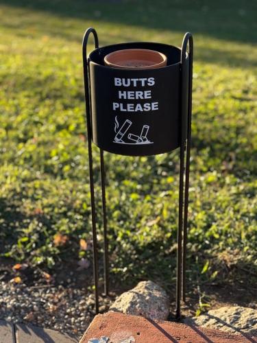 a black sign sitting on top of a rock at Blessed Beyond Measure-King Master with Ensuite in Norwalk