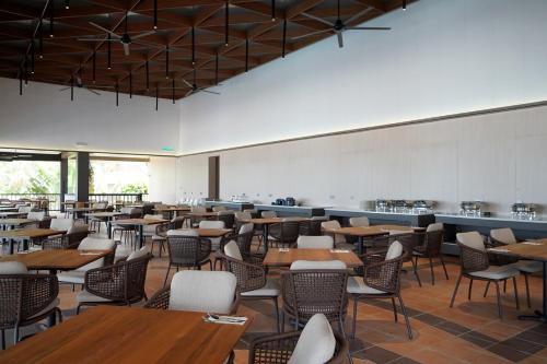a dining room filled with tables and chairs at Peridot By The Sea Redang in Redang Island
