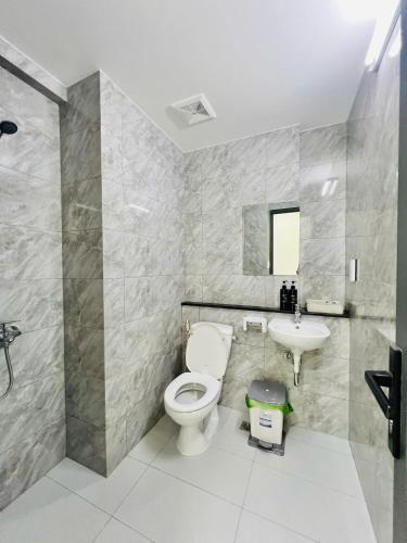 a bathroom with a toilet and a sink at New Lavida in Dĩ An