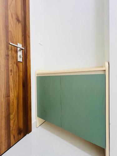 a greenboard in a room next to a door at New Lavida in Dĩ An