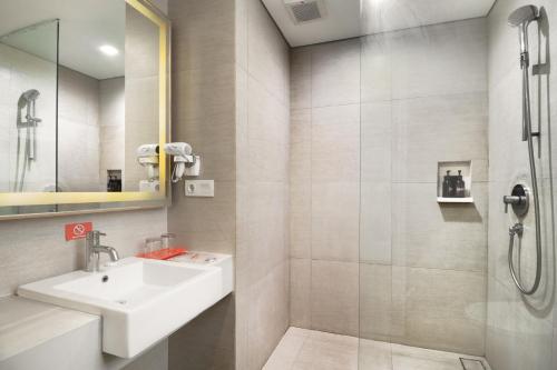 a bathroom with a sink and a shower at HARRIS Hotel Kuta Galleria - Bali in Kuta