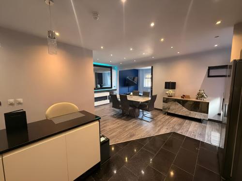 a kitchen and living room with a table and chairs at The Royal Boston Hotel by Compass Hospitality in Blackpool