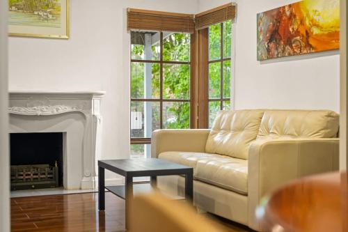 a living room with a couch and a fireplace at Relaxing Ringwood Getaway near Mullum Mullum Trail in Ringwood