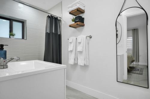 a white bathroom with a sink and a shower at Suite Azul Miami - Private Guest Suite with Patio, Free Parking, Near Wynwood and Beaches in Miami