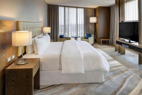 a hotel room with a large bed and a television at The Westin Santa Fe, Mexico City in Mexico City