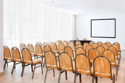 a row of chairs lined up in a room at Sheraton Milan Malpensa Airport Hotel & Conference Centre in Ferno