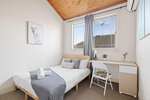 a bedroom with a bed and a desk and a window at Standard Double Room - Convenient Spot in Bexley - Shared Bathroom in Sydney