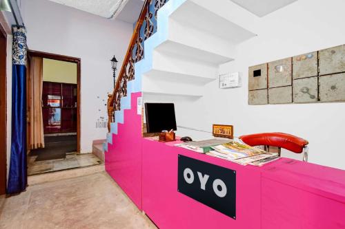 a pink counter with a sign on it at Hotel O Monalisa Guest House in Bhubaneshwar
