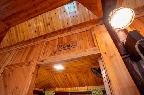 a wooden building with a sign that reads plan at Eco Farmer House - Sapa Retreat in Sa Pa