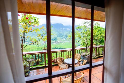 a view of a balcony with a table and chairs at Eco Farmer House - Sapa Retreat in Sa Pa