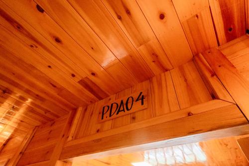 a wooden ceiling with a sign on it at Eco Farmer House - Sapa Retreat in Sa Pa