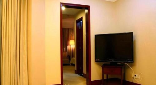 a room with a flat screen tv in a hotel room at Quanzhou Royal Prince Hotel in Quanzhou
