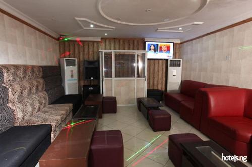 a waiting room with couches and chairs and a television at Prince Of Anthony 1960 Hotel-apartment in Lagos