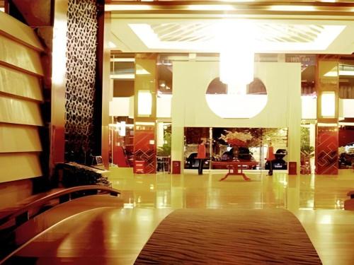 a lobby with a rug on the floor of a building at Lijiang Waika Hotel in Lijiang