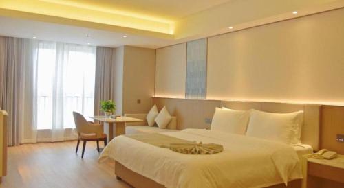 a hotel room with a large bed and a desk at Chengdu Antai Century Hotel in Chengdu