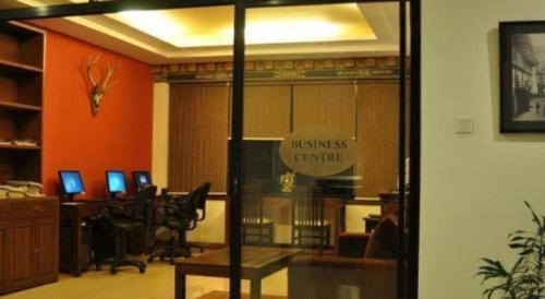 an office with a library with desks and computers at Khang Residency Thimphu in Thimphu