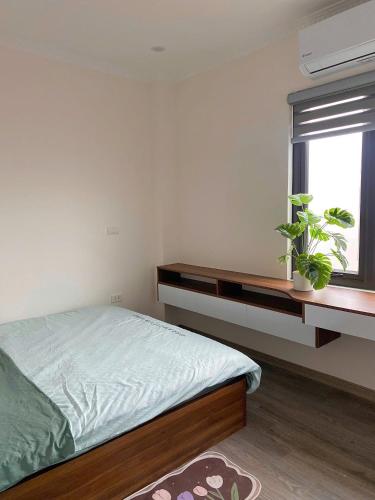 Ένα ή περισσότερα κρεβάτια σε δωμάτιο στο Hera West Lake Apartment