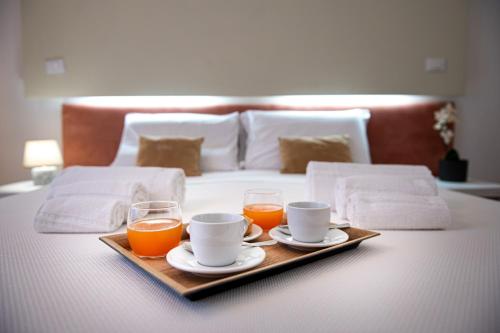 a tray with two cups and two glasses of orange juice at Tenuta San Nicola in Novoli
