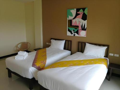 two beds sitting next to each other in a room at The Nest Krabi Hotel in Ao Nang Beach