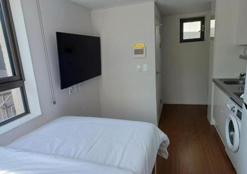a bedroom with a bed and a flat screen tv at 스테이한남 in Seoul