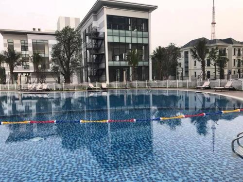 a large swimming pool in front of a building at GreenBay- G34030 in Hanoi