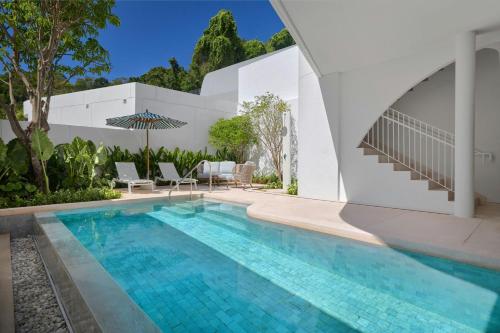 a swimming pool in the backyard of a house at Veranda Resort Phuket, Autograph Collection in Panwa Beach