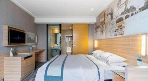 a large bedroom with a large bed and a tv at City Comfort Inn Lichuan Railway Station Tenglong Cave in Enshi