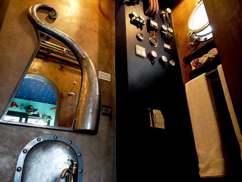 a bathroom with a mirror and a sink at Hotel Sakamanga in Antananarivo
