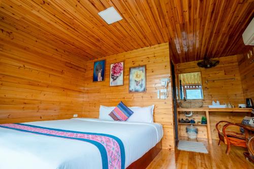 a bedroom with two beds in a wooden room at Eco Farmer House - Sapa Retreat in Sa Pa