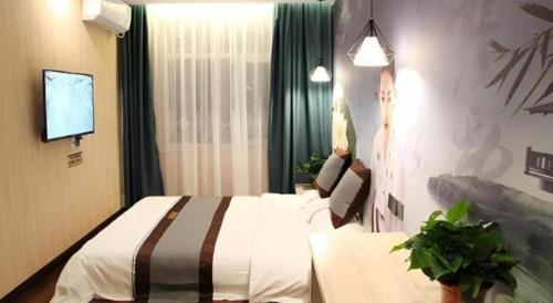 a hotel room with a bed and a tv at City 118 Selected Hotel Xi'an Fengcheng Nan Road in Xi'an