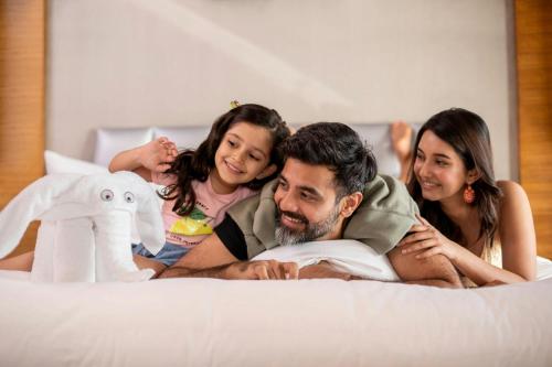 a group of people laying on a bed at JW Marriott Mumbai Juhu in Mumbai