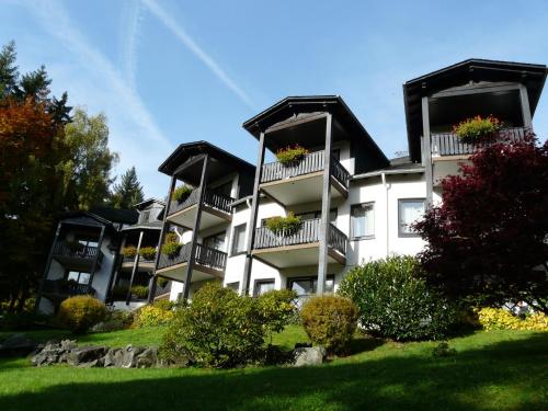 a large white building with balconies and flowers on it at Romantik Hotel Stryckhaus in Willingen