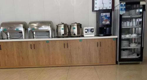 a counter in a store with coffee machines on it at GreenTree Inn Dalian Jinzhou District Railway Station Ansheng Plaza in Dalian