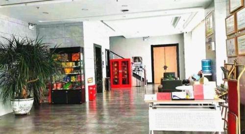 a large room with a potted plant in a store at GreenTree Inn Express Datong High-Speed Railway Station Wanda Plaza Fangte in Datong