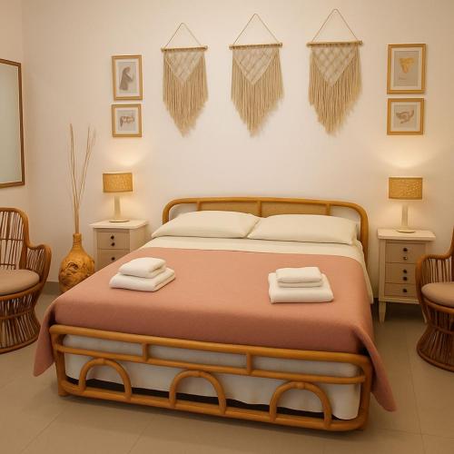 a bedroom with a bed with two towels on it at LA MURGIA casa vacanze B&B in Grumo Appula