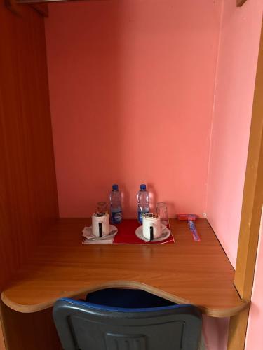 a wooden table with two bottles of water on top of it at Gladstone Main House in Nyeri