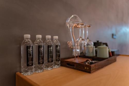 a group of glass bottles on a wooden table at 雾里观阵山 Foggy Valley in Zhangjiajie
