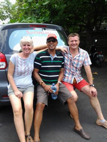 three people sitting on the back of a car at Kubu Pilatus – Family House Lombok in Tjakranegara