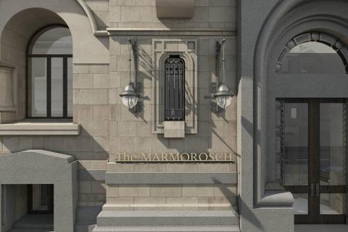 a building with a sign on the side of it at The Marmorosch Bucharest, Autograph Collection in Bucharest