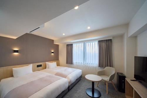 Postel nebo postele na pokoji v ubytování Hotel Eins Osaka Kadoma City Station