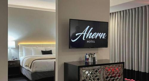 a hotel room with a bed and a sign on the wall at Ahern Hotel and Event Center in Las Vegas