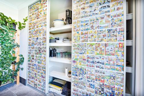 a room with a wall covered in comics at Luxe Cosy Room in Beechboro in Perth
