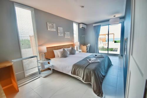 a bedroom with a bed and a large window at Ocean View Ishigaki Kaze and Nami in Ishigaki Island