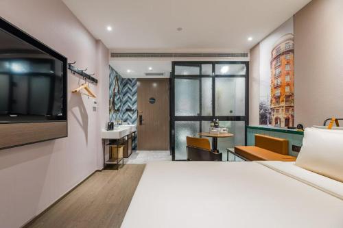 a hotel room with a large bed and a bathroom at Atour Light Hotel Shanghai Jing'an Natural History Museum, Suzhou River Bank in Shanghai