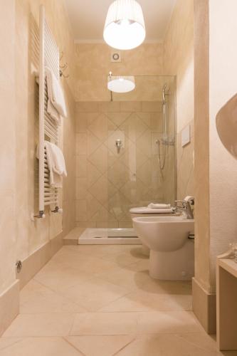a bathroom with a toilet and a shower and a sink at Residenza Marchesi Pontenani in Florence