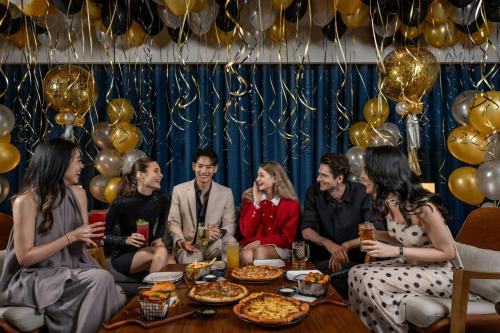 a group of people sitting around a table in a party at Four Points by Sheraton Bangkok, Sukhumvit 22 in Bangkok