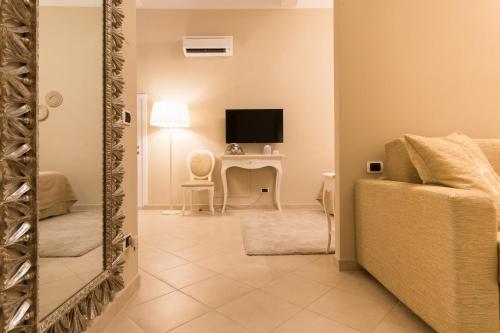 a living room with a couch and a desk at Residenza Marchesi Pontenani in Florence