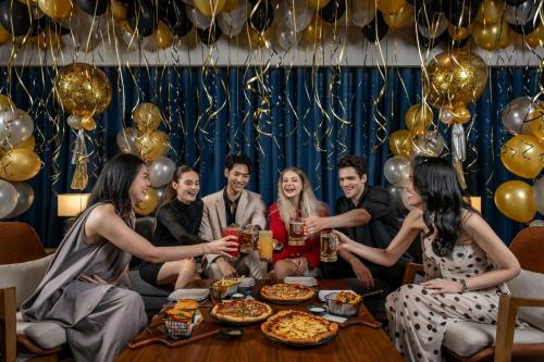 a group of people sitting around a table with drinks at Four Points by Sheraton Bangkok, Sukhumvit 22 in Bangkok