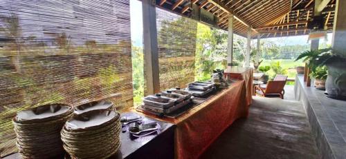 a kitchen with a counter and a large window at The Hidden Gem of Jembrana Bali in Mendaya