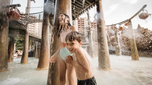 a woman and a boy in a water park at Aulani, Disney Vacation Club Villas in Kapolei